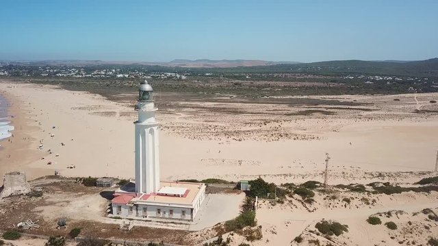 Aerial view of Cape Trafalgar, drone passing close to lighthouse.  South-west of Spain, Cadiz. Atlantic Ocean, northwest of the Strait of Gibraltar. In 1805 naval Battle of Trafalgar took place here.