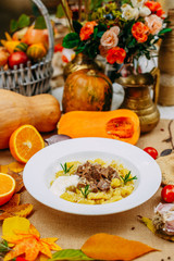 Autumn table setting with pumpkins. Thanksgiving dinner.sliced ​​boiled dough with meat