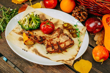 Autumn table setting with pumpkins. Thanksgiving dinner. Steak with Vegetables