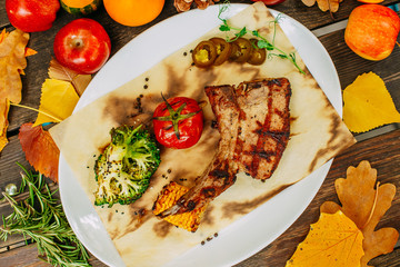 Autumn table setting with pumpkins. Thanksgiving dinner. Steak with Vegetables