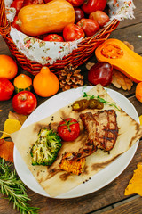 Autumn table setting with pumpkins. Thanksgiving dinner. Steak with Vegetables