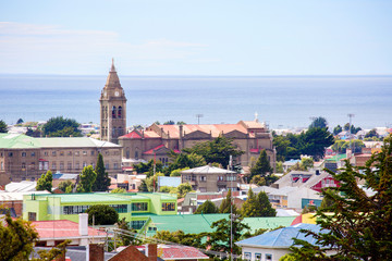 Punta Arenas, Chile, Cityscape.
 View of the city and the Strait of Magellan from above. On the left you can see the tower with a spire. this is the largest Church in the city - the Sanctuary of Maria
