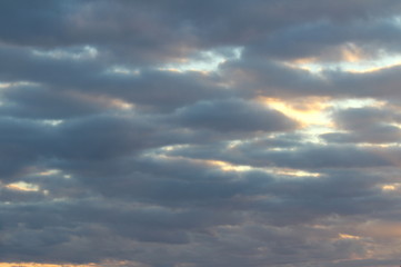 Obraz premium The suns rays pass through the dark clouds. Beautiful dramatic sky at sunset or sunrise.