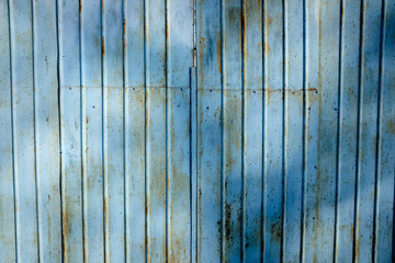 Old blue rusty metal gate with rust. Texture.