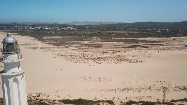 Aerial view of Cape Trafalgar, drone passing close to lighthouse.  South-west of Spain, Cadiz. Atlantic Ocean, northwest of the Strait of Gibraltar. In 1805 naval Battle of Trafalgar took place here.