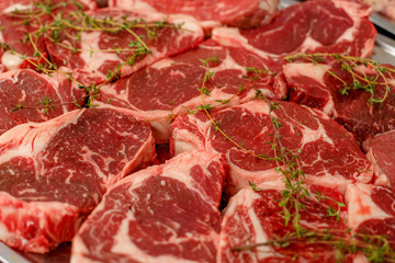 raw steaks with rosemary for cooking