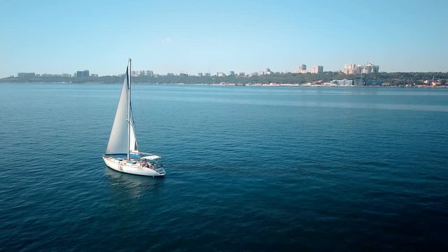 Yacht sailing on opened sea. Sailing boat. Yacht from drone. Yachting video. Yacht from above. Sailboat from drone. Sailing video. Yachting at windy day. Yacht. Sailboat.