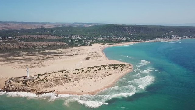 Aerial view of Cape Trafalgar lighthouse,  Cadiz, south-west of Spain. Atlantic Ocean, northwest of the Strait of Gibraltar. In 1805 naval Battle of Trafalgar took place here. Back dolly video