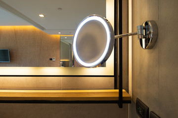 Round shape make-up mirror with lights in the bathroom at the hotel