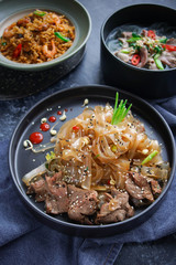 Asian Cuisine, Spicy Asian Beef Noodles, Pho Bo and seafood rice on dark background