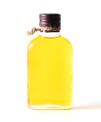 Yellow oil in a glass bottle isolated on a white