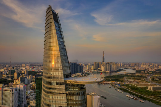 Aerial panoramic cityscape view of HoChiMinh City and Bitexco tower , Vietnam with blue sky at sunset. 