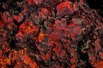 Close up background photo on the texture of a large stone of red jasper