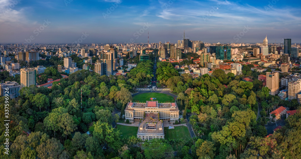 Wall mural Aerial panoramic cityscape view of Independence Palace or Reunification Palace and center Ho Chi Minh City, Vietnam with blue sky at sunset. 