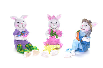 Three cute porcelain bunny rabbits ready for the Easter holiday, isolated on white background