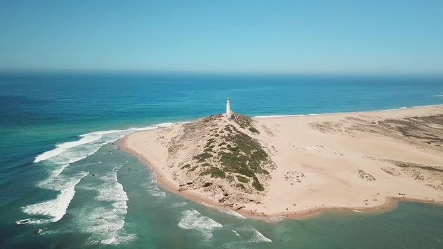 Aerial view of Cape Trafalgar lighthouse,  Cadiz, south-west of Spain. Atlantic Ocean, northwest of the Strait of Gibraltar. In 1805 naval Battle of Trafalgar took place here. Back dolly video