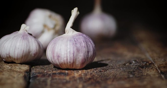 Head of fresh garlic fall on the table.