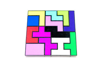 Multi-colored puzzle made of plastic blocks, solved, isolated on white background