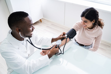 Doctor's Hand Checking Blood Pressure
