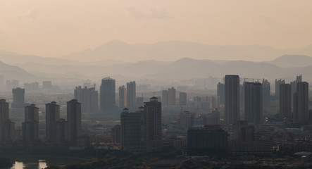 High-rise buildings in misty cities.