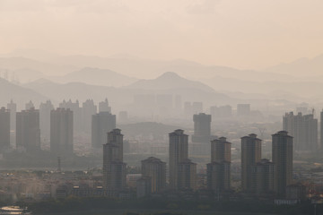 High-rise buildings in misty cities.