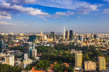 Fototapeta premium Top view aerial photo from flying drone of a Ho Chi Minh City with development buildings, transportation, energy power infrastructure. Financial and business centers in developed Vietnam.