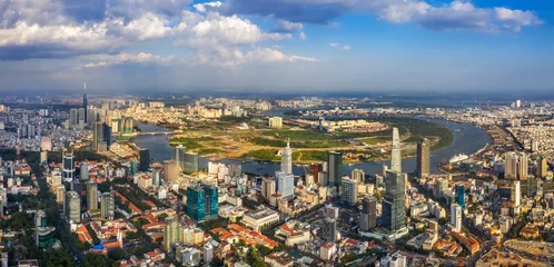Fotobehang Top view aerial photo from flying drone of a Ho Chi Minh City with development buildings, transportation, energy power infrastructure. Financial and business centers in developed Vietnam. © Hien Phung