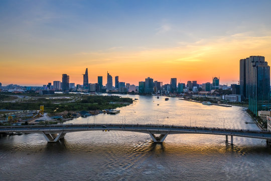 Top view aerial photo from flying drone of center city, a developed metropolitan with office skyscrapers and business center.Ho Chi Minh city with tall buildings. Thu Thiem bridge
