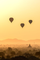 Fototapeta na wymiar Hot air balloon over plain of Bagan in misty morning, Myanmar