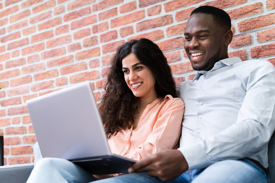 Happy Mature Couple Working On Laptop