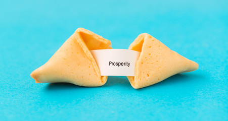 Traditional Chinese new year fortune cookies on blue background.