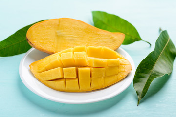 Ripe mango fruit sliced to cubes on white plate ready to eating, tropical fruit, Thai mango (Nam...