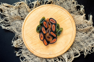 fruit pastille from apples and apricots and blackcurrants and blueberries, and gooseberries or kiwi, dried fruit and berry puree sheets. Organic food. Natural products.