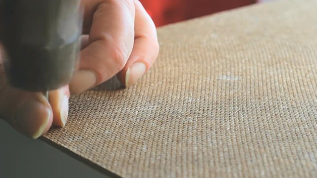Self-Assembly furniture. a metal nail is driven into the LDF. Man hands closeup. Old hammer