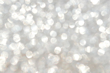 The bokeh of the patterned surface of the silver glitter plate.