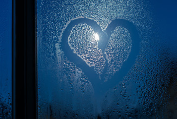 Moonlight through the window. Sweaty glass and heart