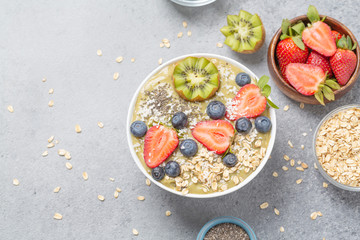 Smoothie bowl with kiwi, banana, Chia seeds, muesli and fresh berries. Healthy breakfast