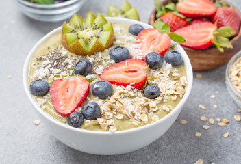 Smoothie bowl with kiwi, banana, Chia seeds, muesli and fresh berries. Healthy breakfast