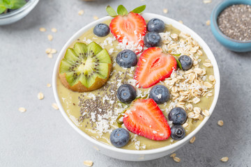 Smoothie bowl with kiwi, banana, Chia seeds, muesli and fresh berries. Healthy breakfast
