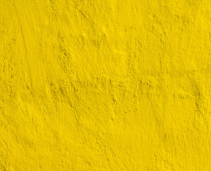 yellow decorative plaster background , golden stucco wall with copyspace , color abstraction , wallpaper close up.