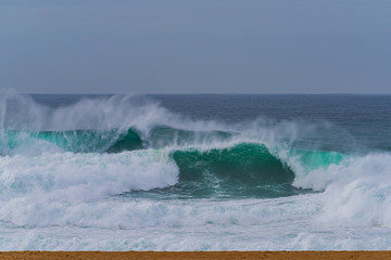 Breaking waves along the Nazare Beach,Portugal - Nazare North Beach is a very famous as surfing point due to big wave.