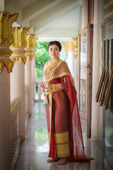 Portrait smiling Asia Girl in Thai Traditional Antique Dress of Old Kingdom in Siam, Southeast Asia.