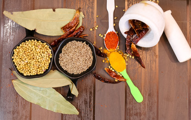 Herbs and Spices with colorful wooden background