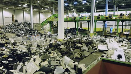 Spacious premises of a junkyard with piles of waste. Waste, plastic trash, garbage recycling plant.