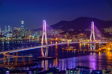Busan harbor bridge lits up at night in different colors. Taken in Busan, South Korea