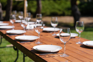 Served wooden table without a tablecloth. Cafe in the open air park