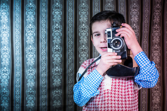 Child taking pictures with vintage camera