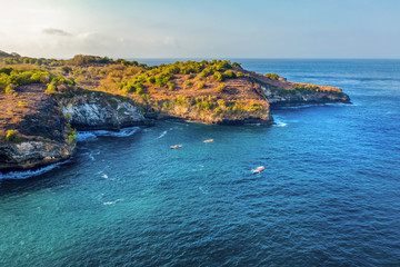 Magnificent view of unique natural rocks and cliffs formation in beautiful beach known as Angel's Billabong beach located in the east side of Nusa Penida Island, Bali, Indonesia. Aerial view.