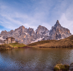 Evening twilight autumn alpine Dolomites mountain scene, Trento, Italy. Lake or Laghetto Baita Segantini view.