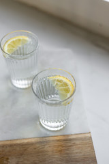 Healthy fresh tonic with lemon, soda in misted glass on marble background